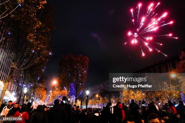 Illustration of Fireworks during the Celebration of Moroccan supporters at Avenue Des Champs Elysees on December 10, 2022 in Paris, France.