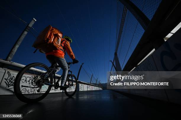 Rider for Just Eat online food order and delivery brand, rides a bicycle in Turin on December 11, 2022.