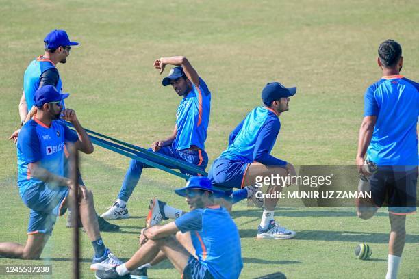 India's cricketers stretch during a practice session at the Zahur Ahmed Chowdhury Stadium in Chittagong on December 11 ahead of their first cricket...
