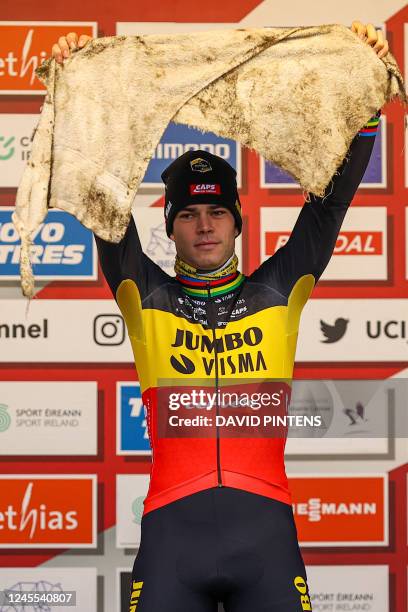 Belgian Wout Van Aert celebrates on the podium after winning the men's elite race of the World Cup cyclocross cycling event in Dublin, Ireland, stage...