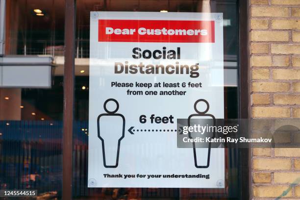 covid-19 signage: physical distancing in stores - grocery store window stock pictures, royalty-free photos & images