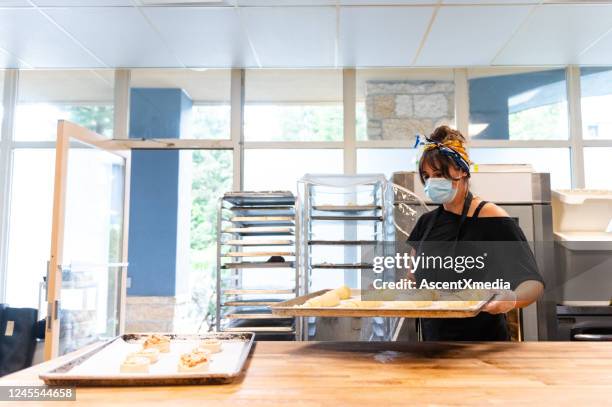 female baker wearing a protective face mask - small business mask stock pictures, royalty-free photos & images