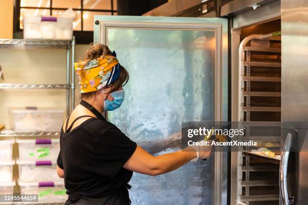 female baker wearing a protective face mask - thermometer stock pictures, royalty-free photos & images