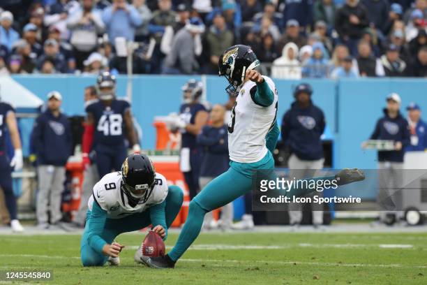 Jacksonville Jaguars place kicker Riley Patterson kicks a field goal from the hold of Jacksonville Jaguars punter Logan Cooke during a game between...