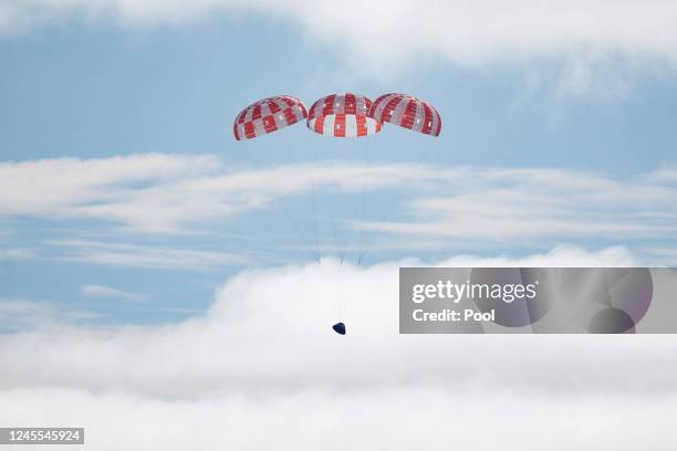 S Orion Capsule splashes down after a successful uncrewed Artemis I Moon Mission on December 11, 2022 seen from aboard the U.S.S. Portland in the...