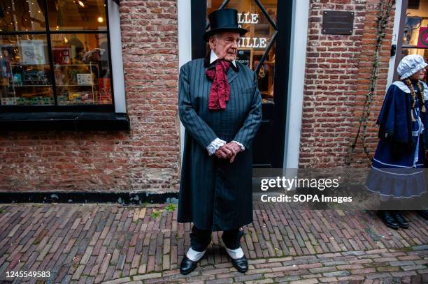 An old man wearing Victorian clothes stands on the street looking at the people passing by. Each year, around this date, the 19th-century world of...