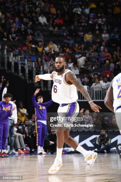 LeBron James of the Los Angeles Lakers sets the play during the game against the Detroit Pistons on December 11, 2022 at Little Caesars Arena in...
