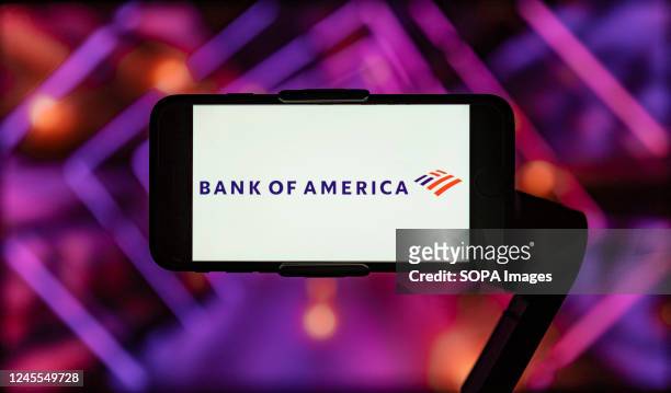 In this photo illustration, the logo of Bank of America is seen displayed on a mobile phone screen.