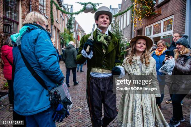 Young couple wearing Victorian clothes seen walking in the middle of the street. Each year, around this date, the 19th-century world of the English...