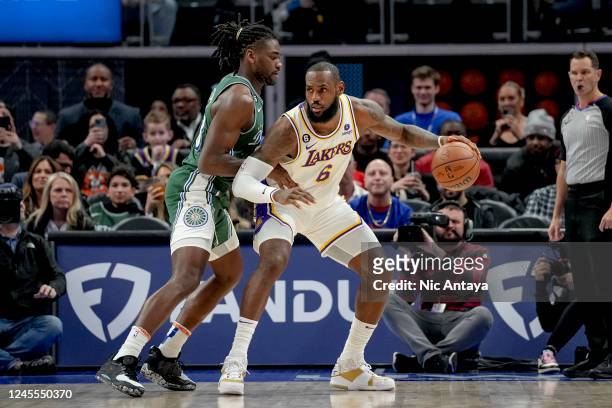 LeBron James of the Los Angeles Lakers handles the ball against Isaiah Stewart of the Detroit Pistons during the first quarter of the game at Little...