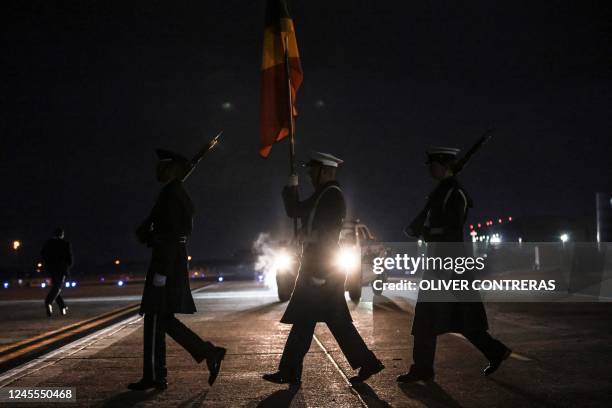 Military Honor Guard approaches the Nigerian delegation's plane as they arrive at Joint Base Andrews in Maryland on December 11 to attend the...