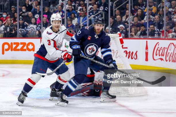 Nick Jensen of the Washington Capitals and Jansen Harkins of the Winnipeg Jets keep an eye on the play during first period action at the Canada Life...