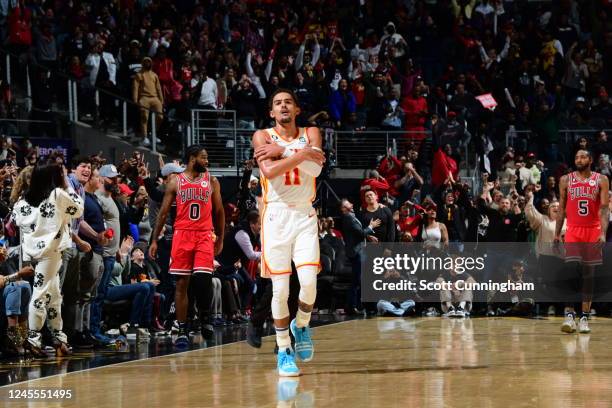 Trae Young of the Atlanta Hawks celebrates a three point basket to gain the lead 121-119 with 1.0 seconds remaining in overtime against the Chicago...