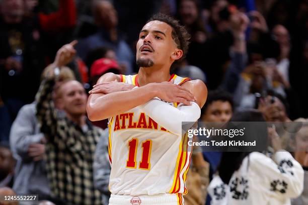 Trae Young of the Atlanta Hawks reacts after a three pointer during overtime against the Chicago Bulls at State Farm Arena on December 11, 2022 in...