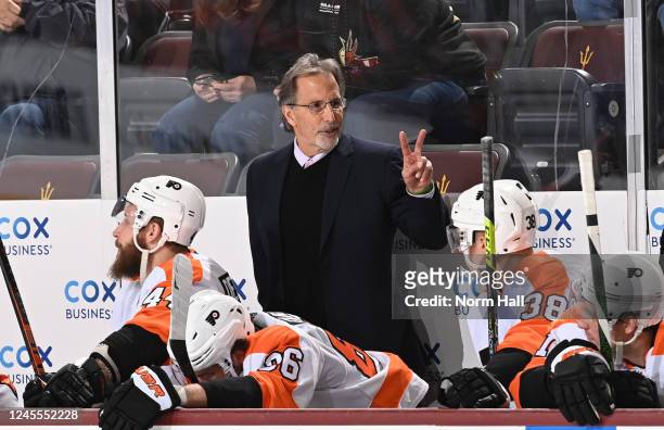 Head coach of the Philadelphia Flyers John Tortorella stands behind the bench during the third period against the Arizona Coyotes at Mullett Arena on...