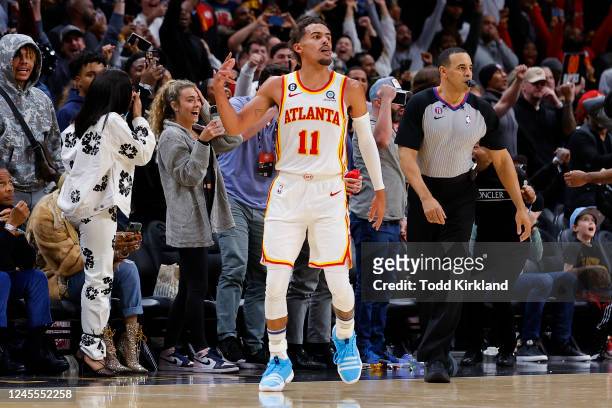 Trae Young of the Atlanta Hawks reacts after a three pointer during overtime against the Chicago Bulls at State Farm Arena on December 11, 2022 in...