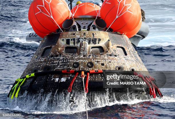 S Orion Capsule is drawn to the well deck of the USS Portland following a successful uncrewed Artemis I Moon Mission after it splashed down in the...