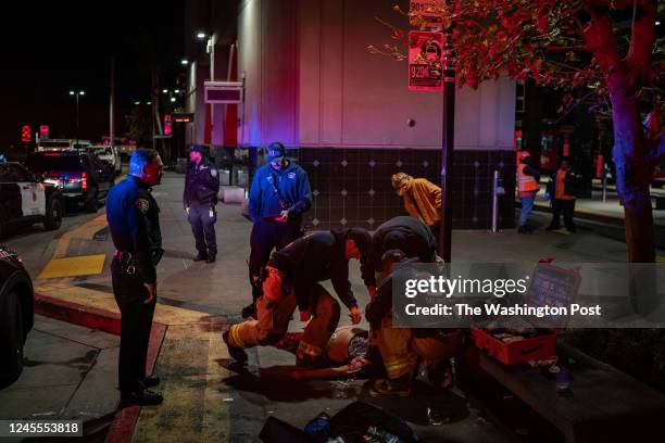 San Diego Police officers and paramedics try to revive a woman who overdosed on fentanyl in San Diego, California, Friday, November 11, 2022.