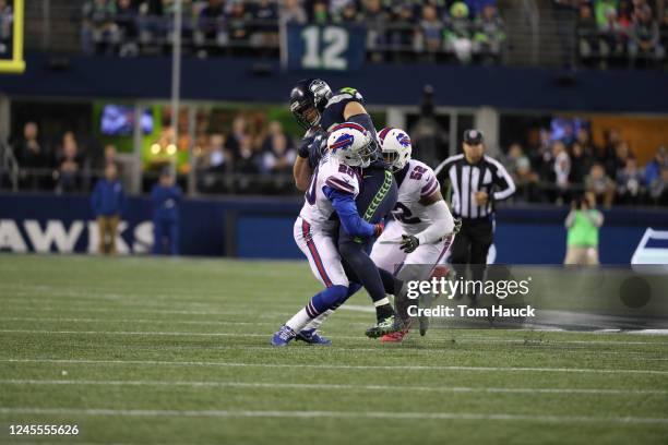 Buffalo Bills free safety Corey Graham tackles Seattle Seahawks tight end Jimmy Graham in action during an NFL game between the Seattle Seahawks and...