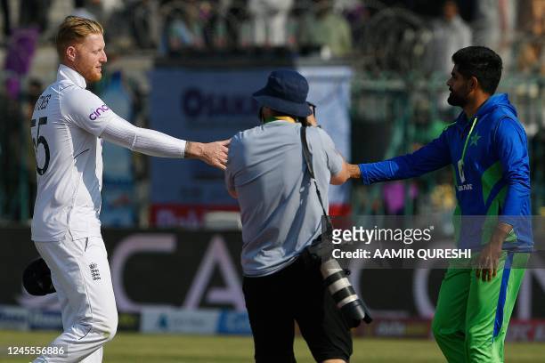 England's captain Ben Stokes shakes hands with Pakistan's captain Babar Azam after England's victory at the end of second cricket Test match between...
