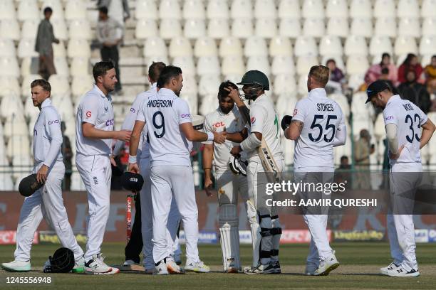 Pakistan's Agha Salman and teammate Mohammad Ali shake hands with England's players at the end of the second cricket Test match between Pakistan and...