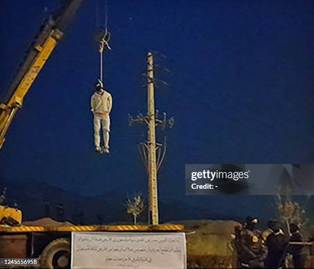 Graphic content / TOPSHOT - A picture obtained from the Iranian Mizan News Agency on December 12 shows the public execution of MajidReza Rahnavard,...