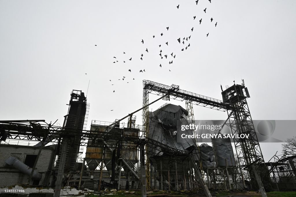 Destroyed Storage Doves fly over a grain storage facility destroyed following missile ...