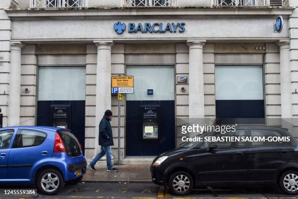 Man walks past a Barclays bank, in the Channel island's port capital Saint Helier, on December 11, 2022.
