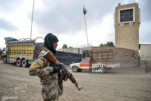 Taliban security personnel stands guard at the Afghanistan-Pakistan border in Spin Boldak on December 12, 2022. - Afghan Taliban forces opened fire...