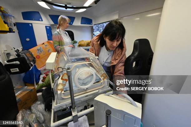 Medical workers examine a specialized vehicle for neonatal resuscitation handed over by the volunteer group Kharkiv Help at the perinatal center in...