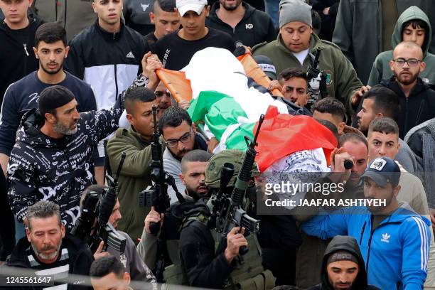 Palestinian gunmen attend the funeral of 16-year-old Jana Zakarnaa, who was killed during an Israeli raid in the occupied West Bank, on December 12,...