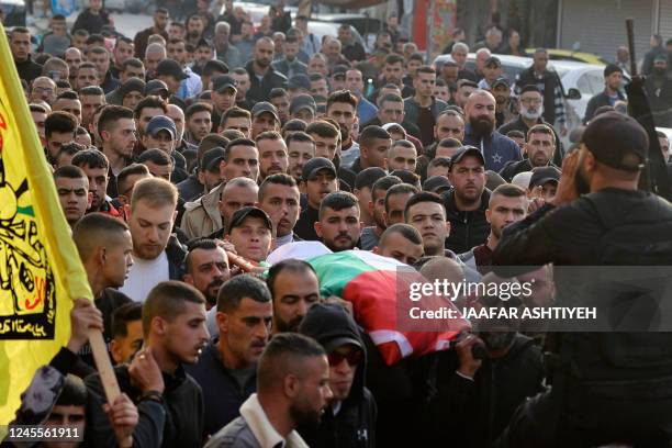 Palestinian mourners attend the funeral of 16-year-old Jana Zakarnaa, who was killed during an Israeli raid in the occupied West Bank, on December...