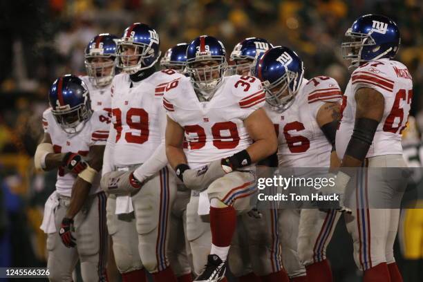 Madison Hedgecock of the New York Giants shivers in the huddle against the Green Bay Packers at the NFC Championship game at Lambeau Field on January...