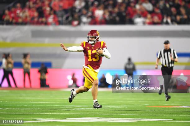 Trojans quarterback Caleb Williams runs up field, looking like he was making a Heisman pose, during the Pac-12 Conference championship game between...