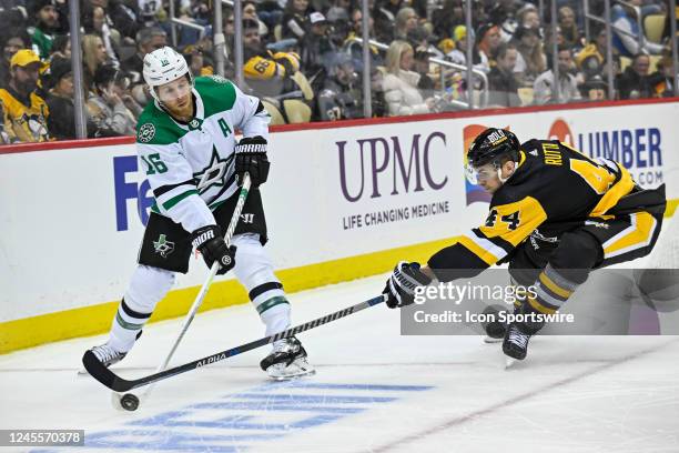 Dallas Stars Right Wing Joe Pavelski and Pittsburgh Penguins Defenseman Jan Rutta go for the puck during the first period in the NHL game between the...