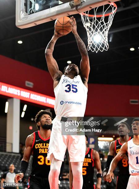 Michael Foster of the Delaware Blue Coats dunks against the College Park Skyhawks on December 12, 2022 at Gateway Center Arena in College Park,...