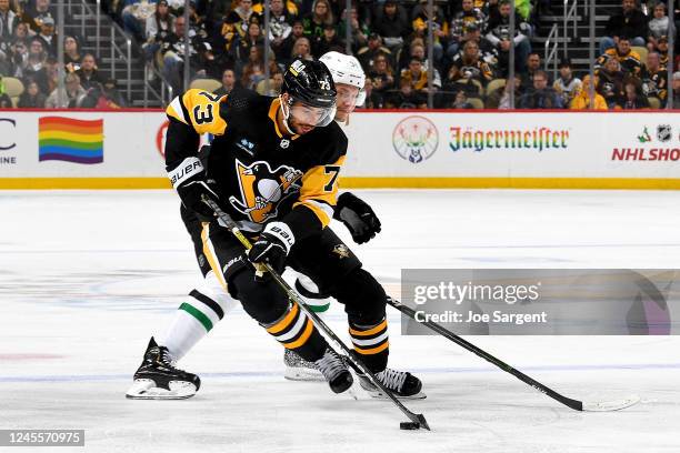 Pierre-Olivier Joseph of the Pittsburgh Penguins handles the puck against the Dallas Stars at PPG PAINTS Arena on December 12, 2022 in Pittsburgh,...