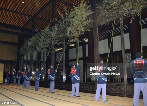 People sweep away dust during year-end cleaning at Naritasan Shinsho-ji temple in Narita, near Tokyo, on Dec. 13, 2022.