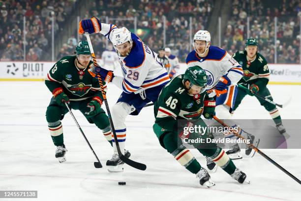 Leon Draisaitl of the Edmonton Oilers skates with the puck past Jared Spurgeon of the Minnesota Wild in the first period of the game at Xcel Energy...