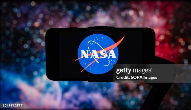 In this photo illustration, the logo of NASA is seen displayed on a mobile phone screen.