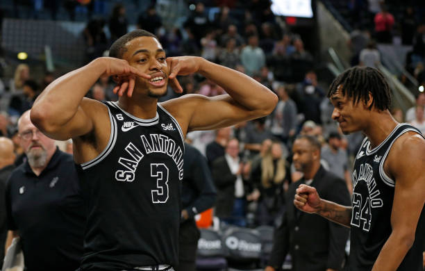 Keldon Johnson of the San Antonio Spurs and Devin Vassell reacts after they defeated the Cleveland Cavaliers at AT&T Center on December 12, 2022 in...