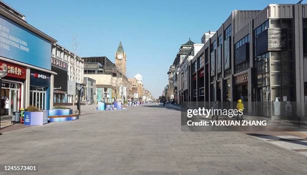 This frame grab from AFPTV video footage shows an almost empty street in the Wangfujing shopping district in Beijing on December 13, 2022.