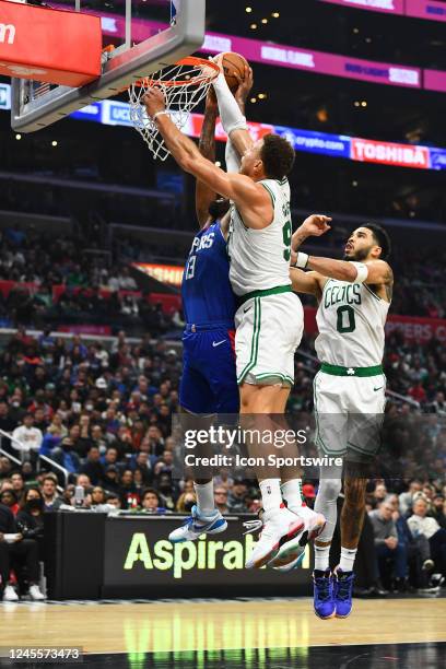Los Angeles Clippers Guard Paul George dunk attempt is blocked by Boston Celtics Center Blake Griffin , who is called for a technical foul for...