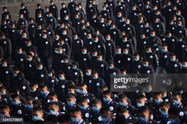 People stand during a silent tribute during a ceremony at the Memorial Hall of the Victims in Nanjing Massacre by Japanese Invaders on the annual...