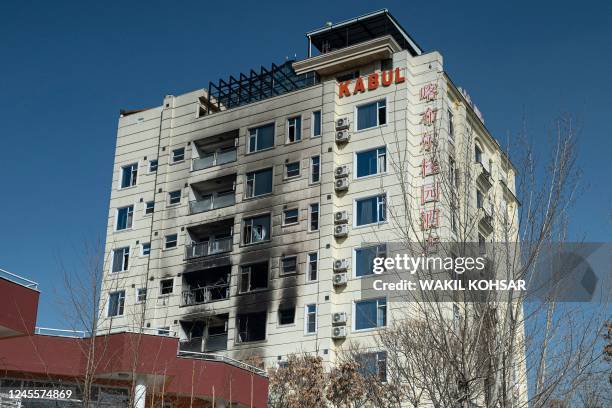 General view shows burnt and broken windows a day after a deadly attack by gunmen at a hotel in Kabul on December 13, 2022. - At least three people...