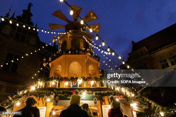 People queue for street food at Angel Mill construction during the Gdansk Christmas Fair. According to the rank of Best Christmas markets in Europe...