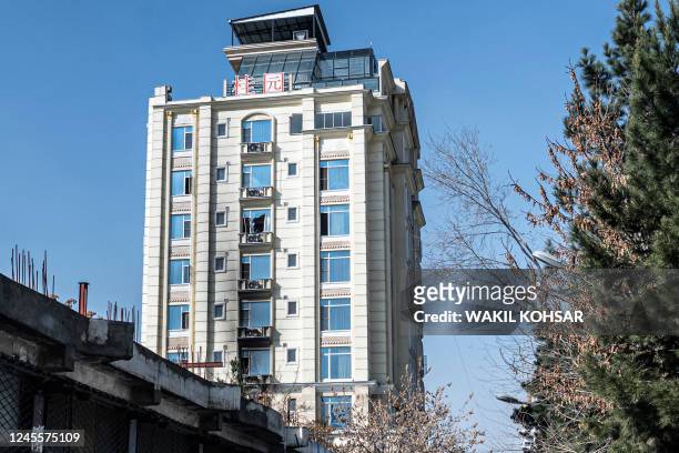 General view shows burnt and broken windows a day after a deadly attack by gunmen at a hotel in Kabul on December 13, 2022. - At least three people...
