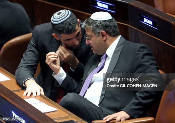 Israeli Knesset member Itamar Ben-Gvir , leader of the far-right Otzma Yehudit party, speaks with the Likud party's Shlomo Karhi during a session...