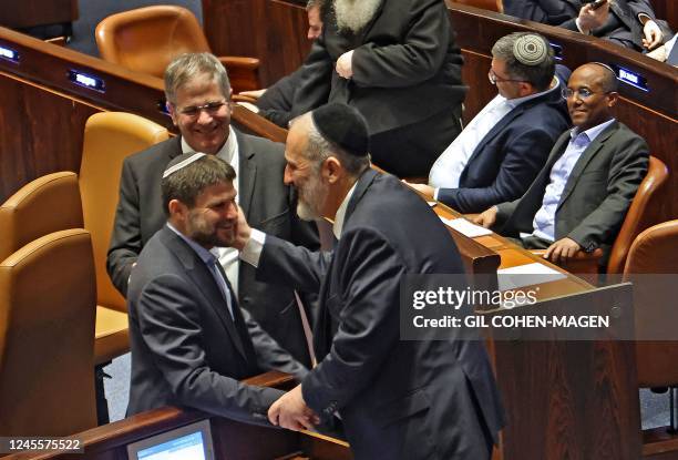 Israeli Knesset member Aryeh Deri of the Haredi religious party Shas speaks with Bezalel Smotrich , leader of the Religious Zionist Party, during a...