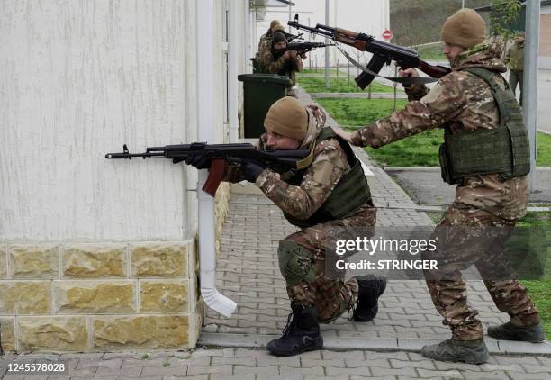 Chechen special forces troops take up firing positions as they attend a training session at a "Russian University of Special Forces" training centre...